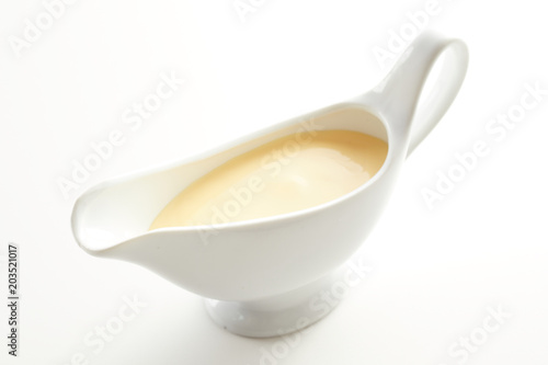 White ceramic sauce boat with Hollandaise sauce