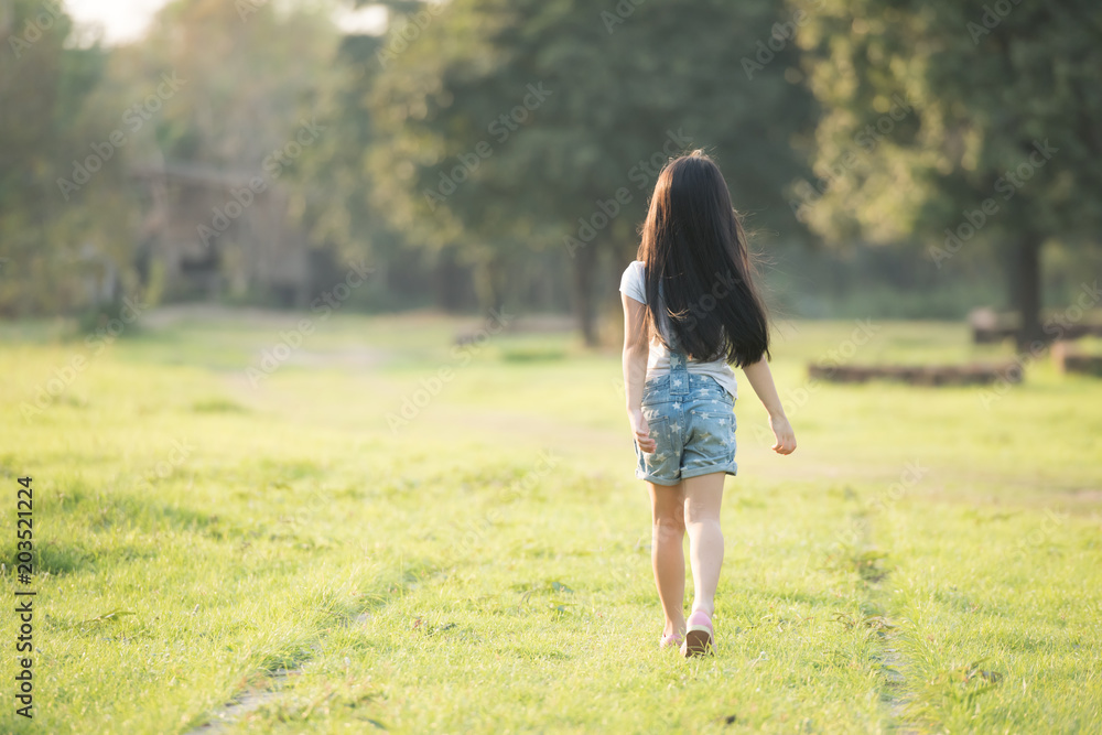 Little girl running on meadow with sunset Little girl running on meadow with sunset