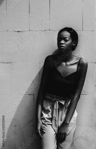 Portrait of a black female fashion model posing  on gray background