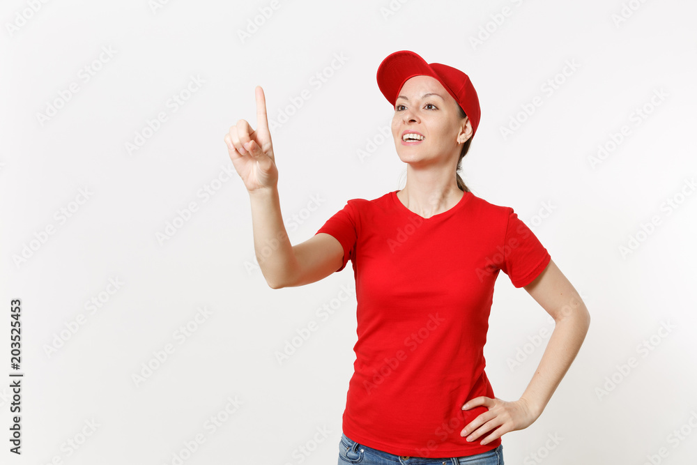 Delivery woman in red uniform touch something like click on button isolated on white background. Female in cap, t-shirt, jeans working as courier or dealer, pointing at floating screen. Copy space.