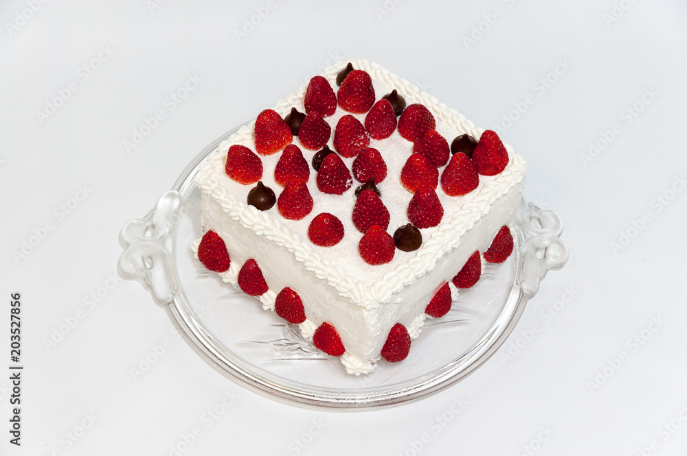 Delicious birthday cake covered with whole strawberries. Top view. Isolated on white background. Closeup. Delicious birthday cake covered with whole strawberries. Top view. Isolated on white background. Closeup.