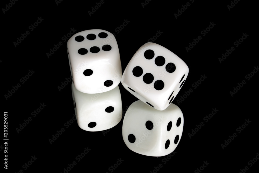 Pair of white dice on black reflective background Pair of white dice on black reflective background