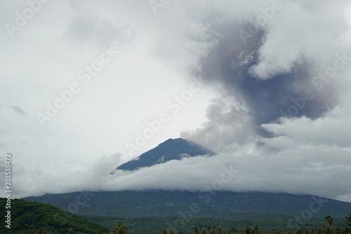 agung volcano erupting cloud of smoke and ashes spreding