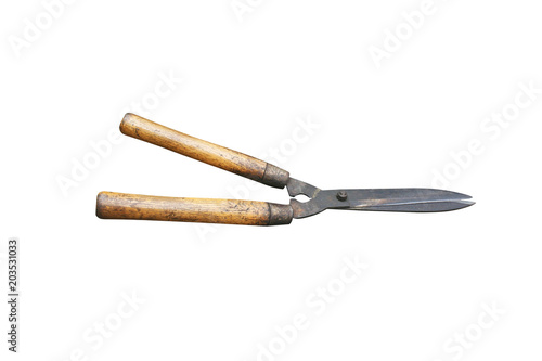 Old grass shears with wooden handle isolated on white background