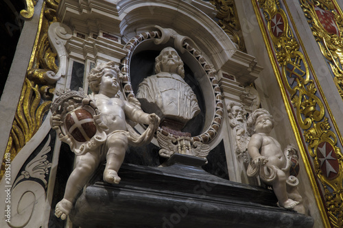 Valletta, Malta St John Roman Catholic Co-Cathedral interior art. Statue carvings which adorn stonewalls inside Baroque art and architecture church built for the Knights of St John. photo