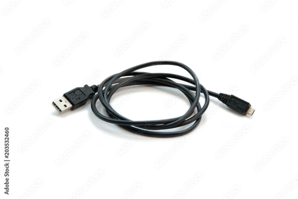 Black USB cable on white background. USB and USB-mini cable connectors close-up. A patch cable or patch cord or patch lead. Black USB cable on white background. USB and USB-mini cable connectors close-up. A patch cable or patch cord or patch lead.