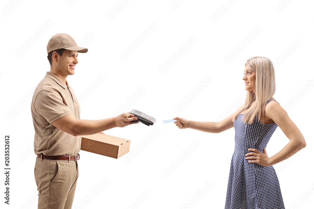 Delivery man holding a package and a payment terminal with a young woman giving him a credit card Delivery man holding a package and a payment terminal with a young woman giving him a credit card