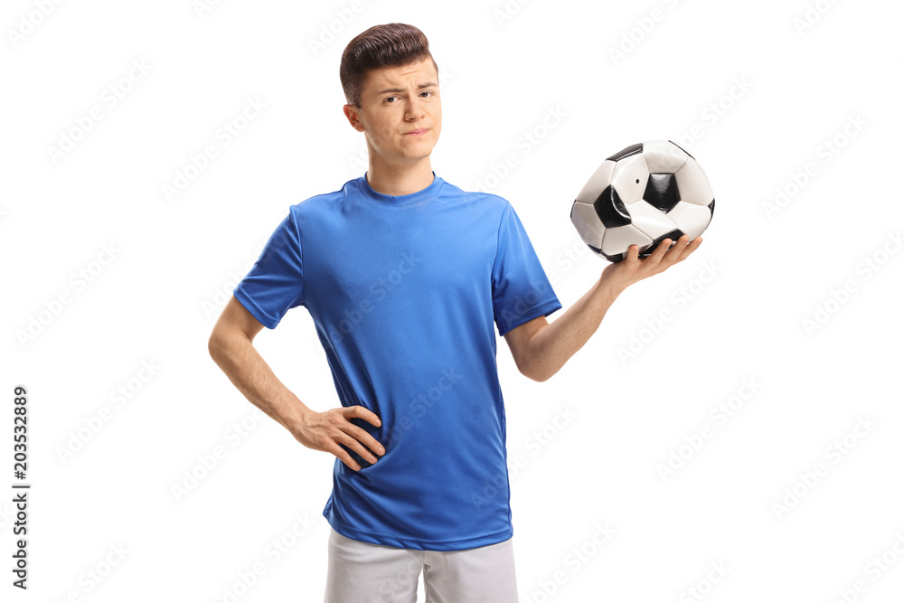 Sad teenage soccer player holding a deflated football