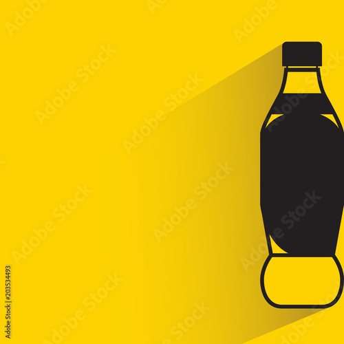 beverage bottle with drop shadow on yellow background