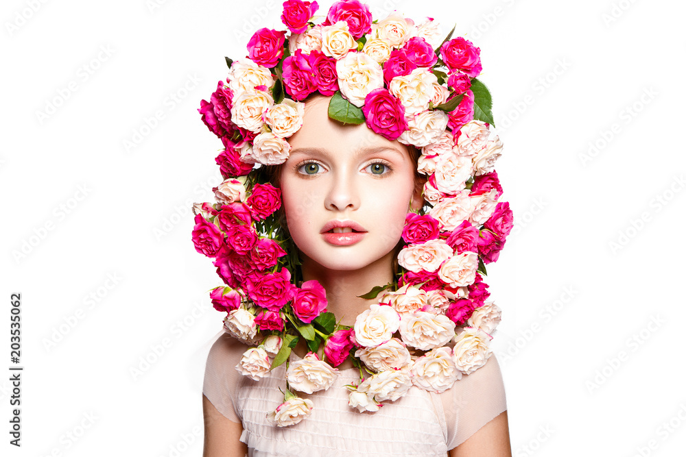 Beautiful baby girl portrait with flowers on head. Young and fresh face.