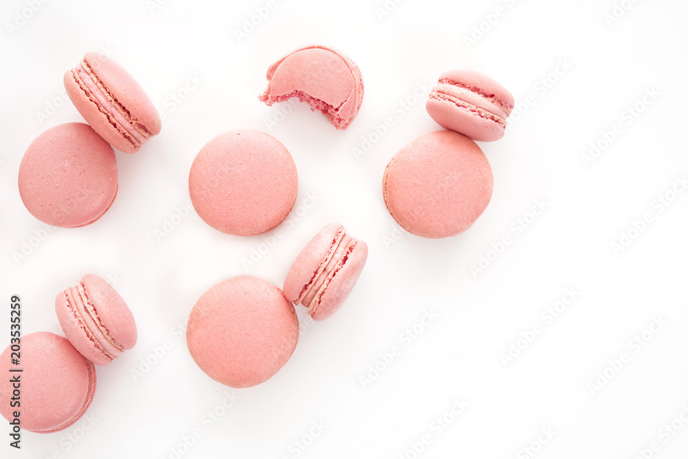 Fototapeta premium Classic french pink macarons on white background. Isolated
