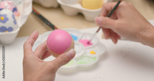 Painting colorful egg for Easter holiday at home