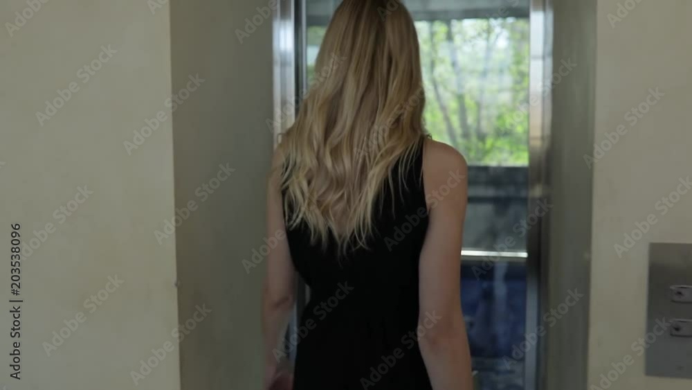 Sexy woman call the elevator and go into it Sexy woman call the elevator and go into it