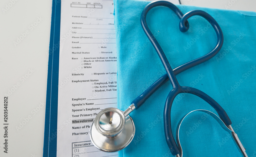 Stethoscope on a table with medical uniform