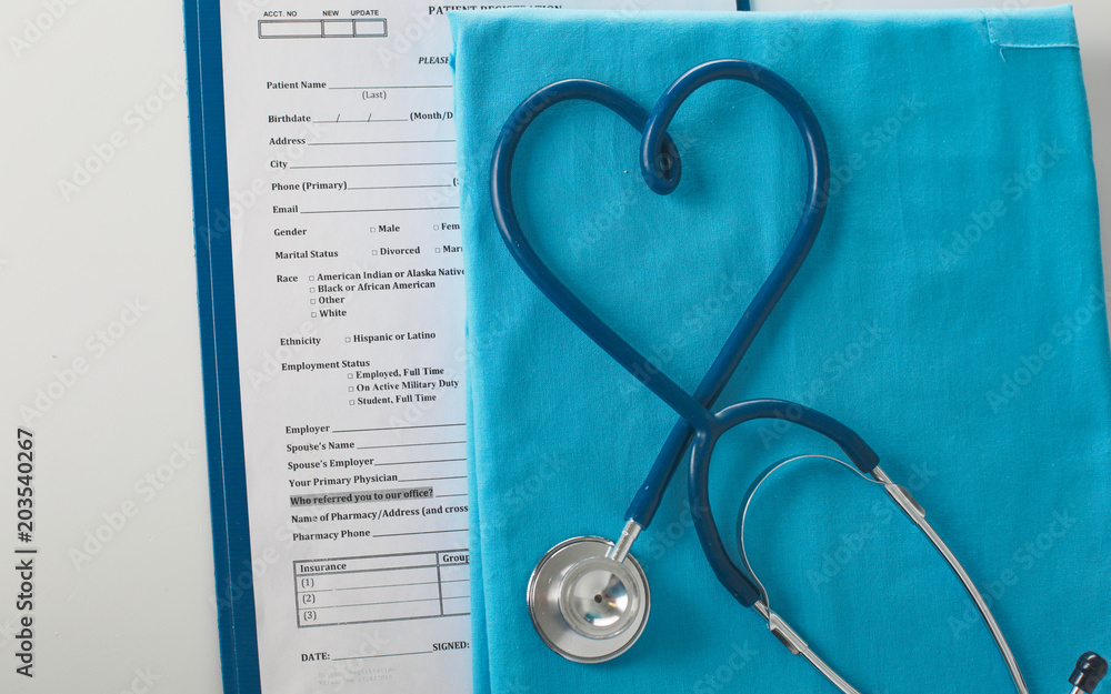 Stethoscope on a table with medical uniform Stethoscope on a table with medical uniform