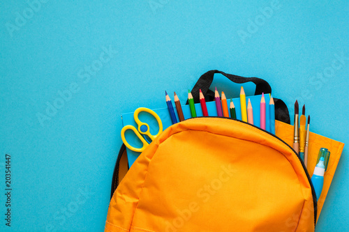 Back to school concept. Backpack with school supplies. Top view. Copy space