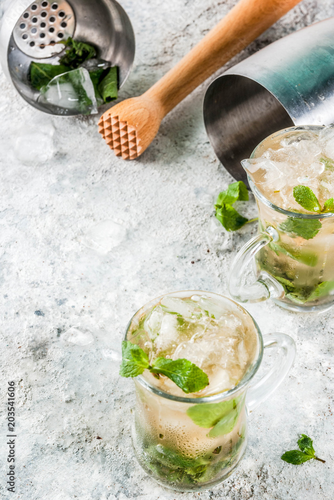 Cold summer beverage, mint julep cocktail drink, grey stone background copy space Cold summer beverage, mint julep cocktail drink, grey stone background copy space