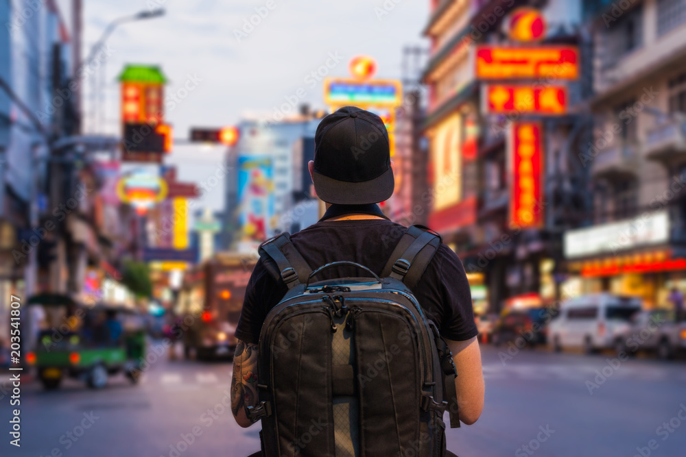Man with backpack in the street of Chinatown in Bangkok, Asia