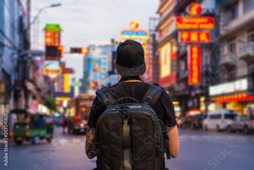Man with backpack in the street of Chinatown in Bangkok, Asia © steph photographies
