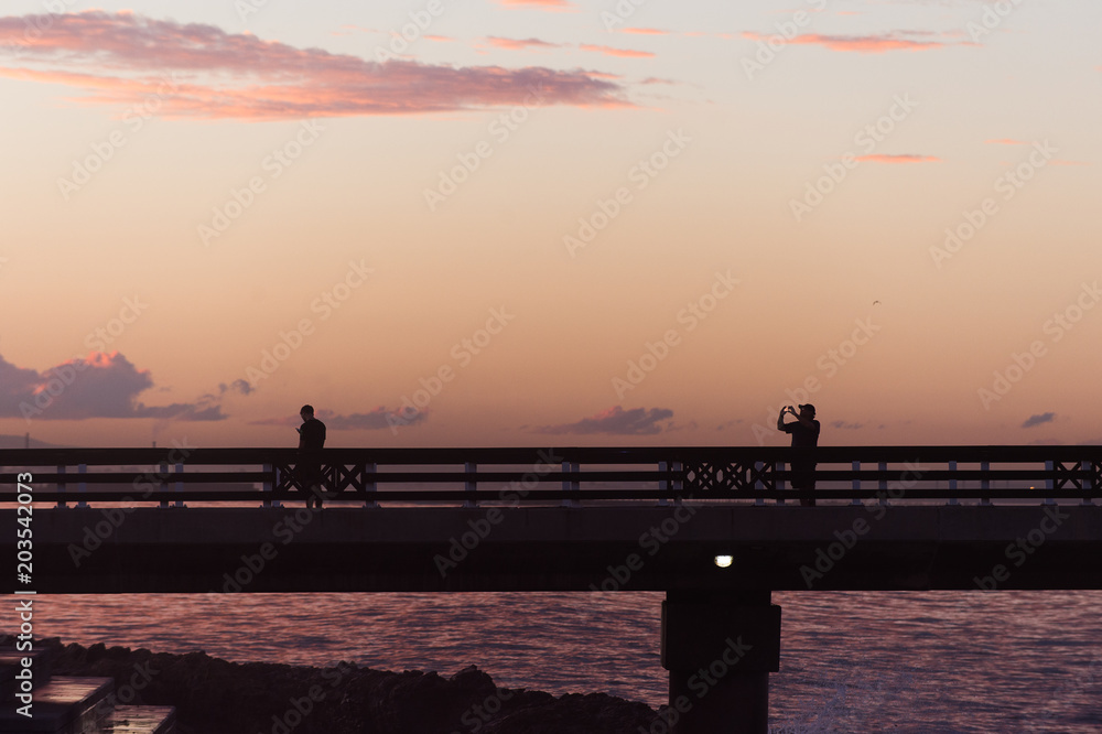 Tourists take photos on the pier Tourists take photos on the pier