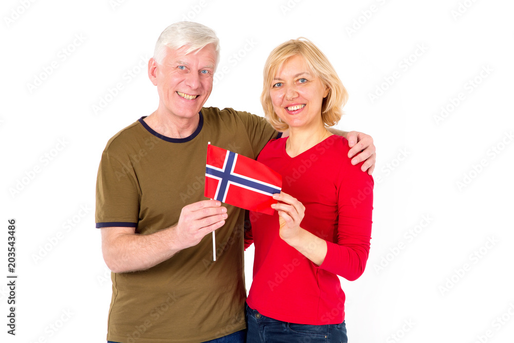 A middle aged man and woman with a Norwegian flag in hands. A middle aged man and woman with a Norwegian flag in hands.