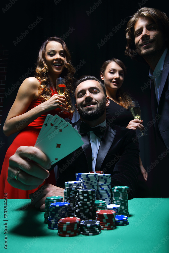 concentrated men and women playing poker in casino concentrated men and women playing poker in casino