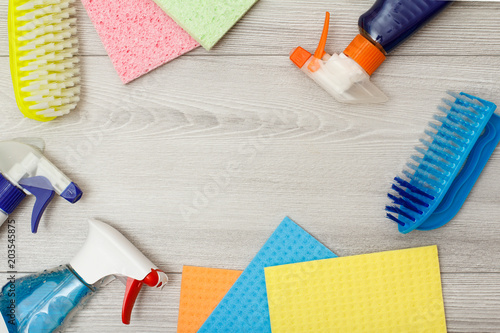 Bottles of detergent, color microfiber napkins and synthetic brush for cleaning