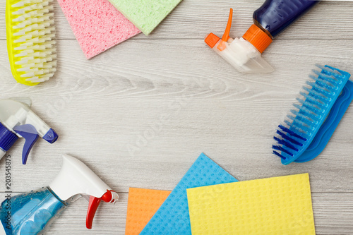 Fotografie Bottles of detergent, color microfiber napkins and synthetic brush for cleaning