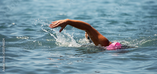 Man swimmer swimming crawl in blue sea,training for triathlon © pavel1964