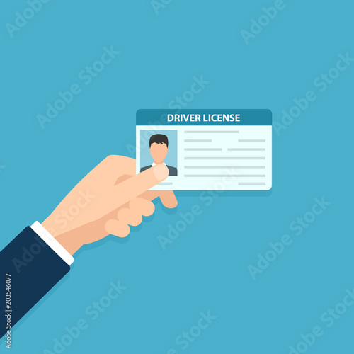 Hand holding car driver license