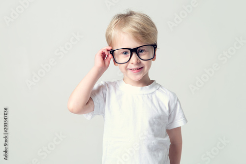 Fototapeta Naklejka Na Ścianę i Meble -  Smart little boy. 4 year old boy wearing glasses.