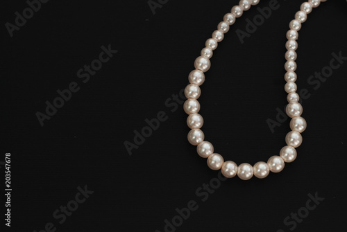 White String Pearls necklace, isolated on black Copy space