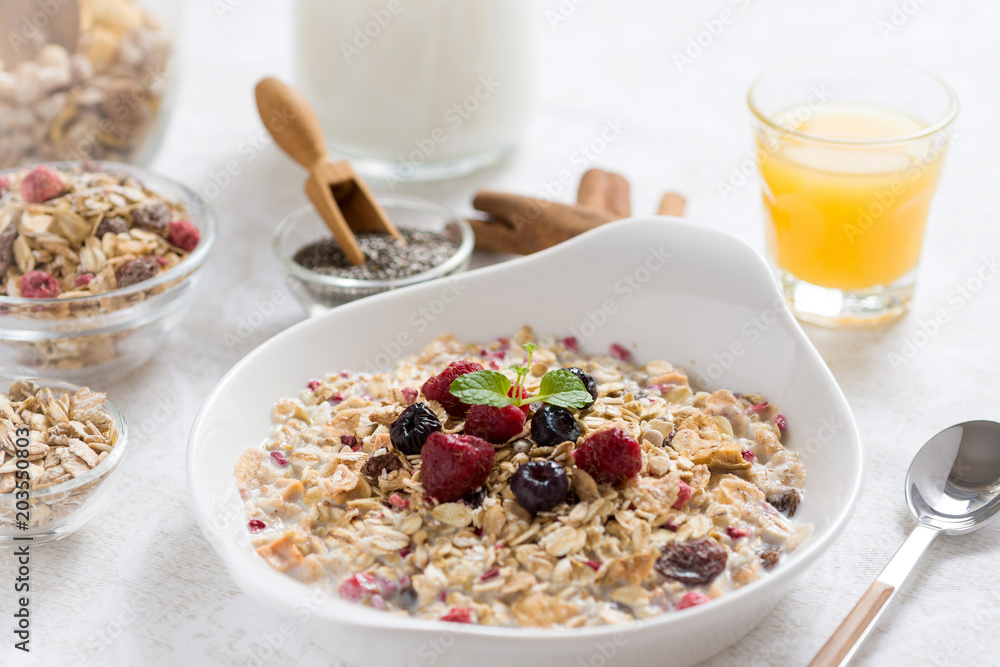 Muesli With Milk, Chia Seeds, Berries and Cinnamon with Freshly Squeezed Orange Juice Muesli With Milk, Chia Seeds, Berries and Cinnamon with Freshly Squeezed Orange Juice