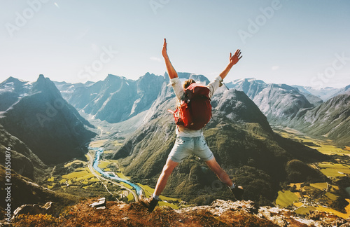 Happy Man traveler jumping with backpack Travel Lifestyle adventure concept active summer vacations outdoor in Norway mountains success and fun euphoria emotions