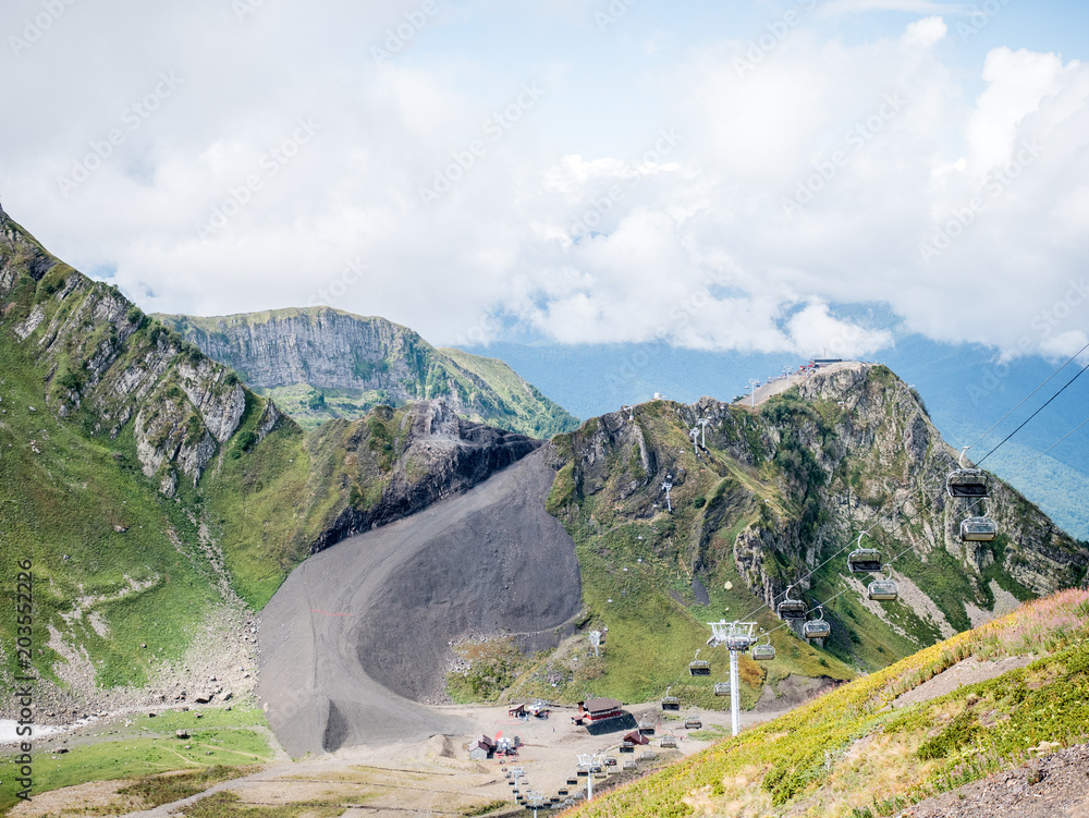 Photo of mountain slopes with vegetation and cloudy sky