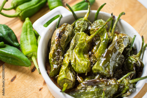 Fried Green Padron Peppers in White Bowl. Pimientos de Padron.