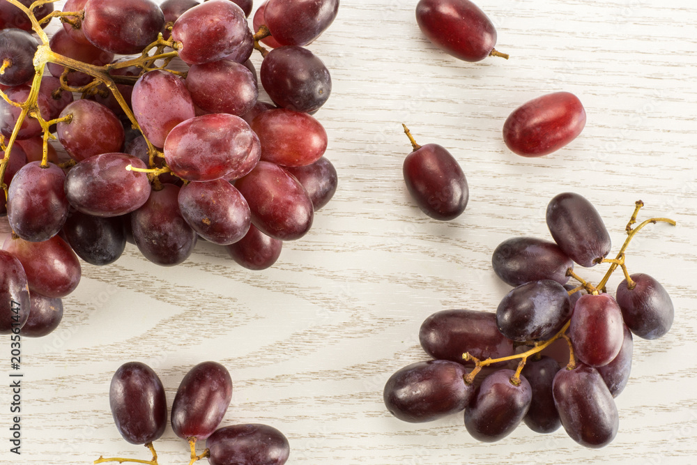 Obraz premium Red globe grape berries table top isolated on grey wood background fresh dark pink.
