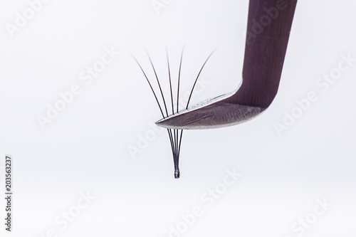 Eyelash Extension tools on white background. Accessories for eyelash extensions. Artificial lashes. 4D, closeup , selective focus. photo