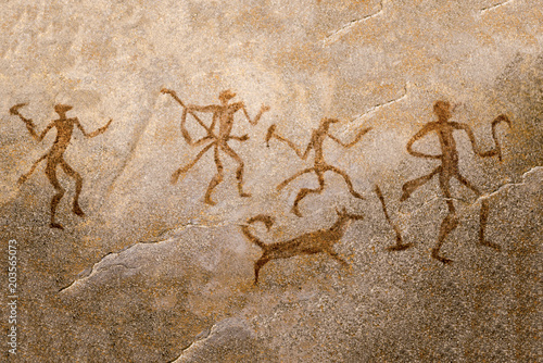 Obraz na plátne image of ancient hunters with a dog on the wall of the cave