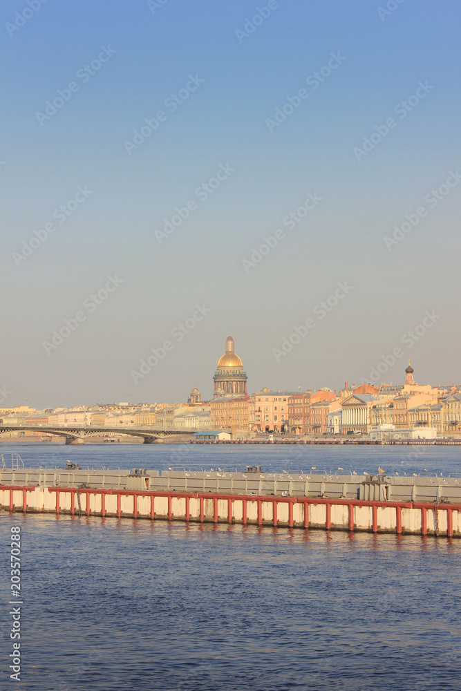 Saint Petersburg Cityscape Over Neva River on Sunset in Russia. City Skyline Colorful Photo with Historical Russian Architecture: Traditional City Drawbridge and St. Isaac's Cathedral on Background.