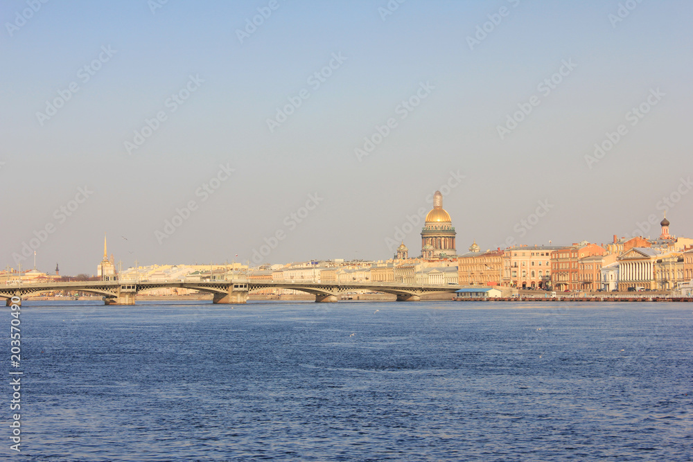 Saint Petersburg City Skyline with St. Isaac's Cathedral and Draw Bridge in Russia. Cityscape Close Up Over the River Water at Dusk Sky Background before Sunset. St. Petersburg Touristic Wallpaper.