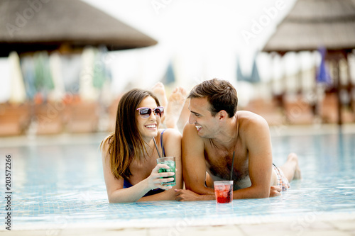 Couple in the swimming pool at summertime