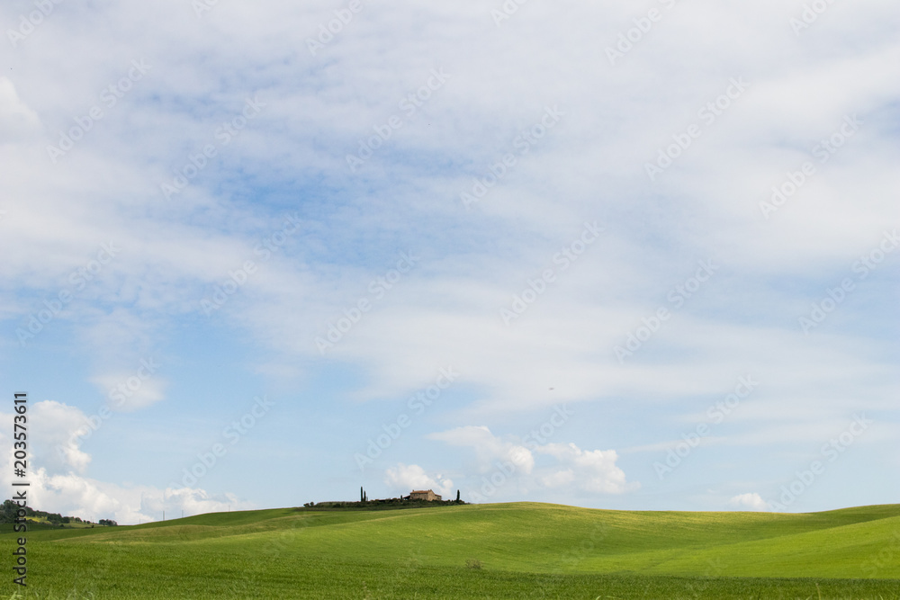 Italian landscape with green fields in spring, holidays in Italy in Umbria and Tuscany. Travel drive in the Tuscany countryside with soft green hills and blue skies. Calm and relax holidays in Italy Italian landscape with green fields in spring, holidays in Italy in Umbria and Tuscany. Travel drive in the Tuscany countryside with soft green hills and blue skies. Calm and relax holidays in Italy