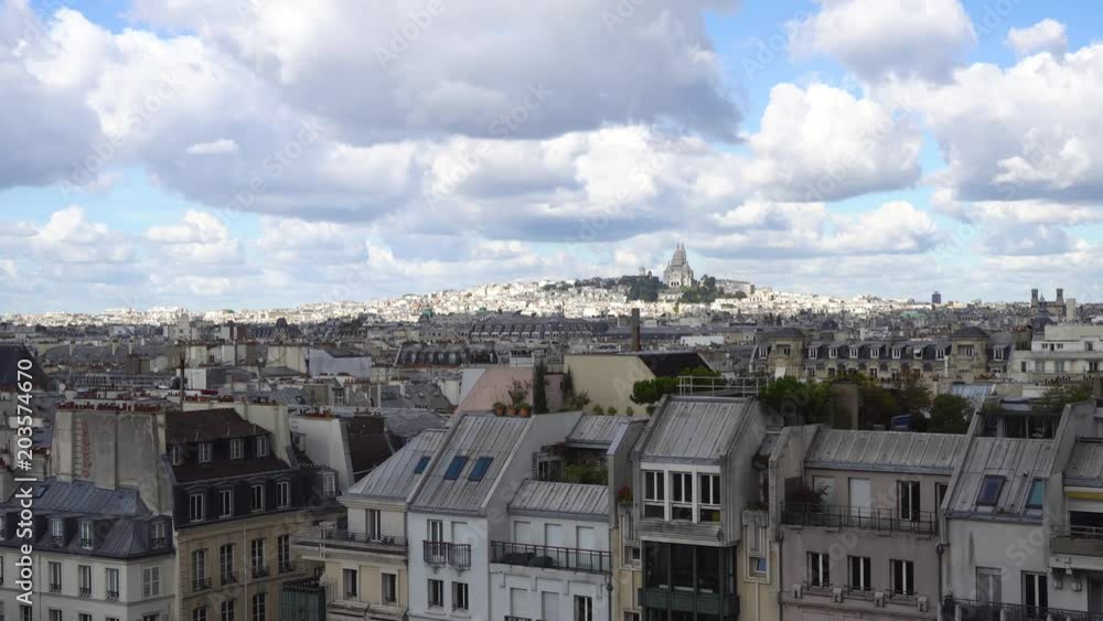 view of Paris Mont Matre hill and parisian roofs ubder blue sky with clouds, France view of Paris Mont Matre hill and parisian roofs ubder blue sky with clouds, France