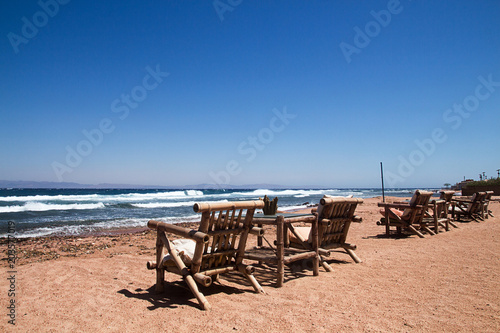  Row of bamboo chaise lounge on beach in Dahab, Sinai, Egypt. Beautiful seascape. Relax time. © twomeerkats