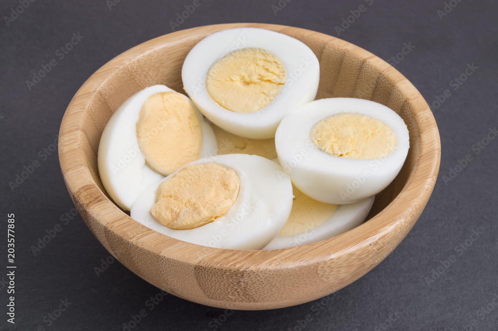 hard eggs peeled and cut in half in a bowl hard eggs peeled and cut in half in a bowl