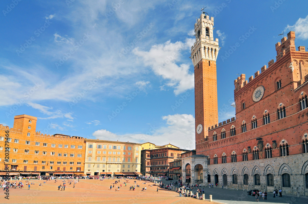 The Torre del Mangia and the Palazzo Publico in The Campo, Siena, Tuscany, Italy.