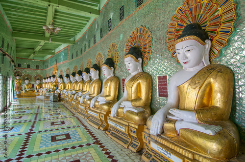 Many seated Buddha sculptures, walls decorated with glass mosaics, Umin Thounzeh, Umin Thonse or U Min Thonze Pagoda, Sagaing Hills near Mandalay, Myanmar. photo