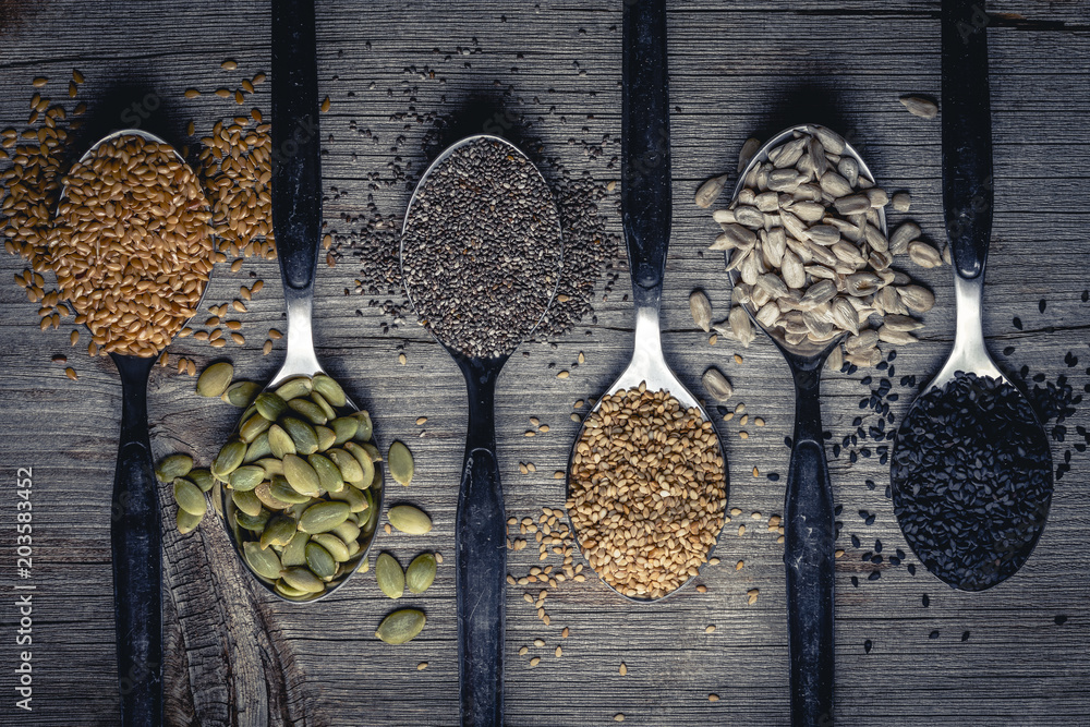 Spoons with assortment of seeds - obrazy, fototapety, plakaty 