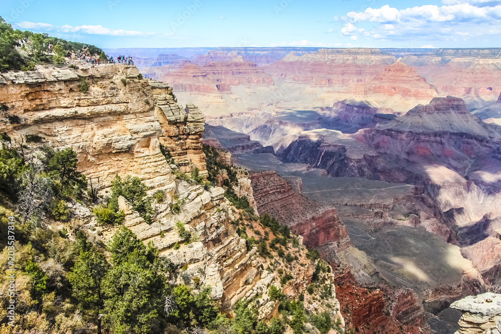 Grand Canyon with tourists on top of the hill